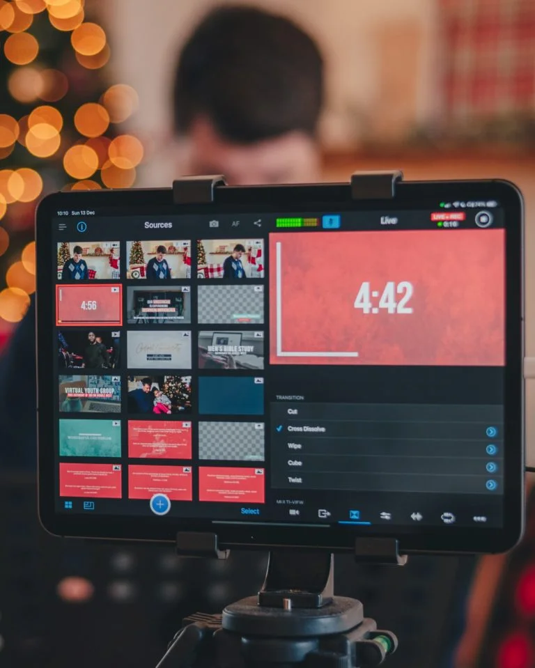 Tablet displaying live streaming control interface with video sources, countdown timer, and transition settings during a livestream setup