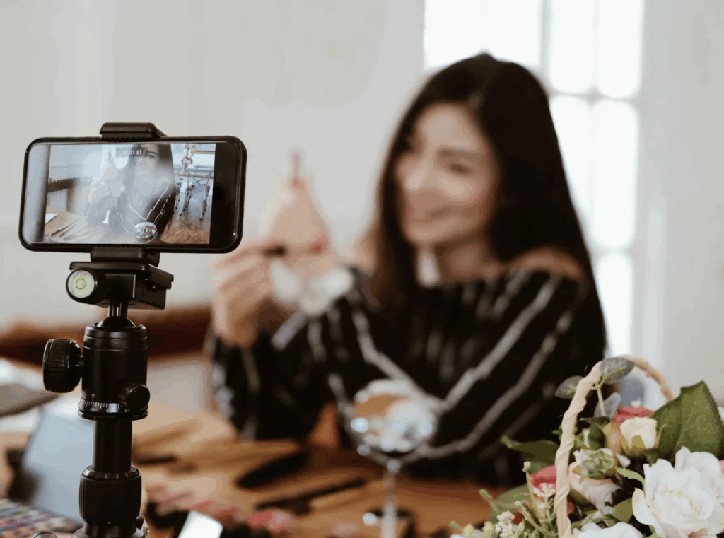 Livestream commerce setup with a creator presenting products on a smartphone camera