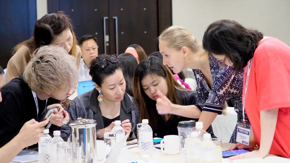 Seminar attendees collaborating on group task with ashley