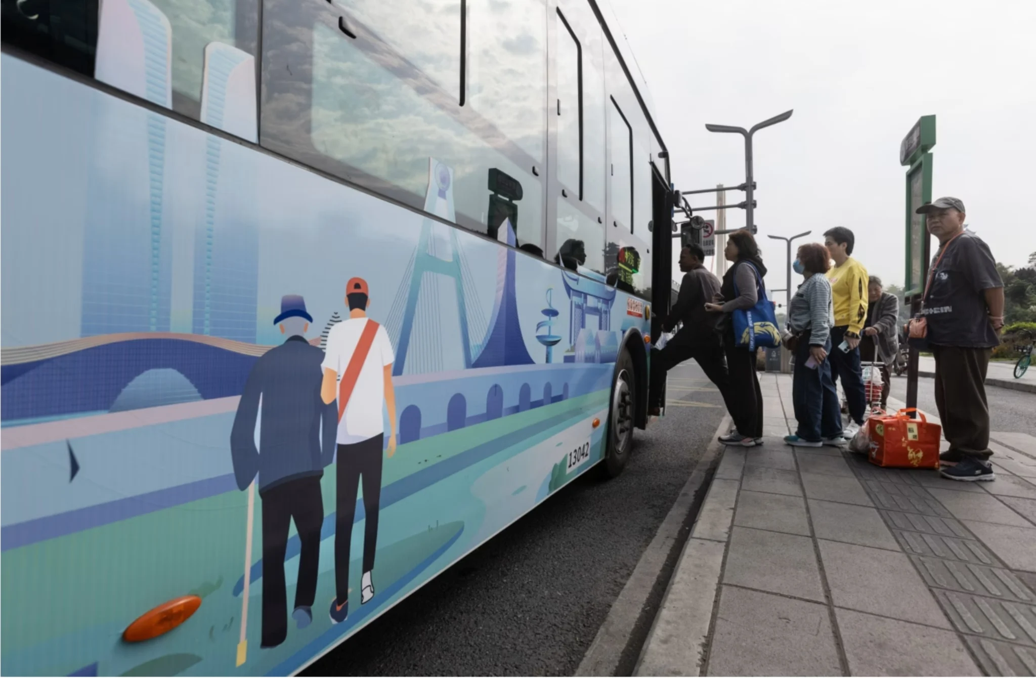 Passengers boarding public bus in modern Chinese city