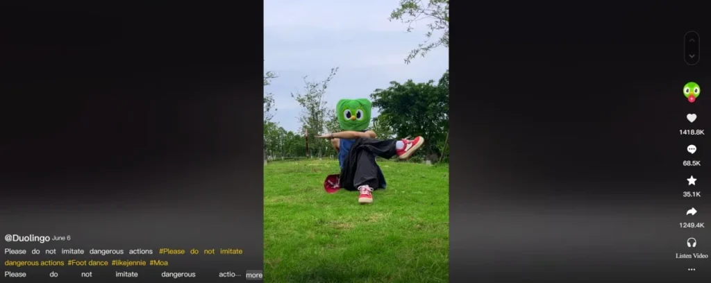 Duolingo mascot performing a casual dance in a grassy outdoor setting in a short-form video