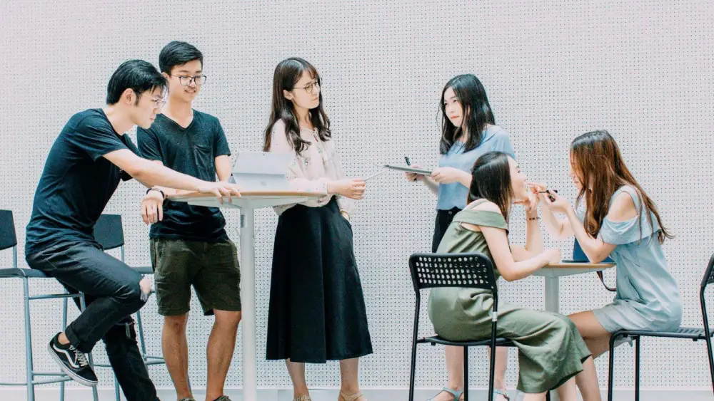 Young professionals collaborating and discussing ideas in a modern workspace