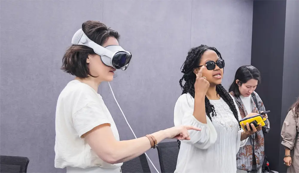 Women demonstrating VR and wearable technology indoors