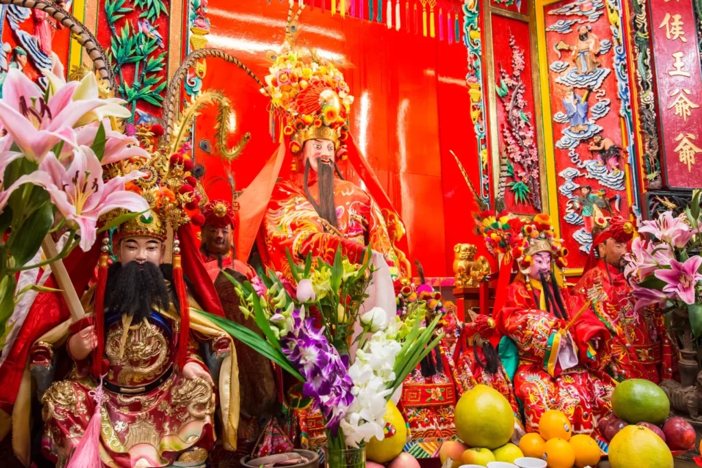 People praying in front of the altar of Pak Tai Temple